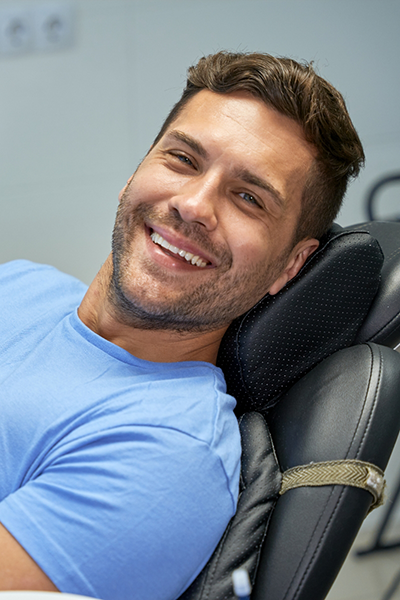 Smiling man leaning back in the dental chair