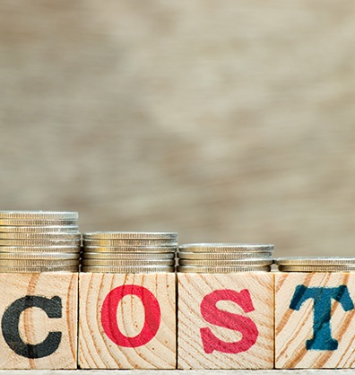 Wooden blocks spelling 'cost'