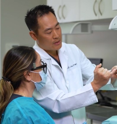 Doctor Steve Lim showing a dental model to a dental team member