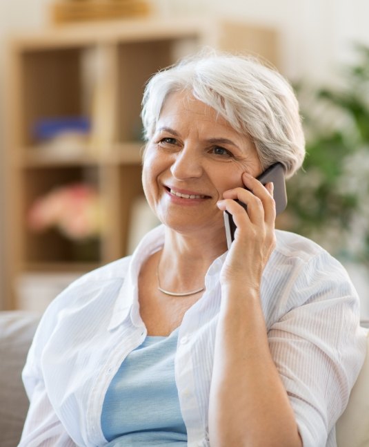 Senior woman talking on the phone with San Jose dental office