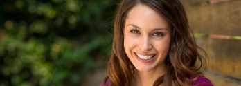 Woman in fuschia blouse smiling