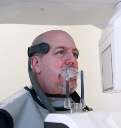 Man having a C T cone beam scan taken of his mouth and jaw