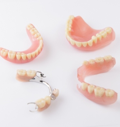 Two full dentures and two partials against white background