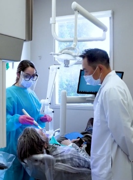 Doctor Lim and assistant treating a dental patient