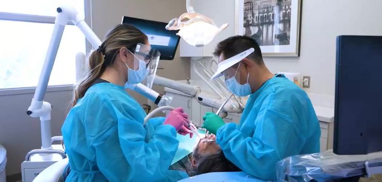 Doctor Lim and dental assistant treating a patient