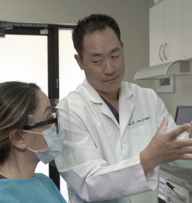 Doctor Lim showing a dental team member something out of frame