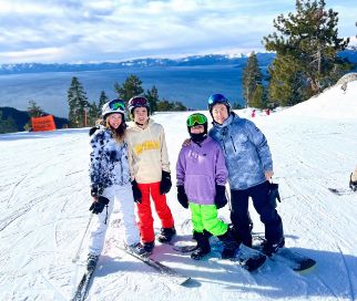 Doctor Lim and his family in ski gear on a snowy mountain