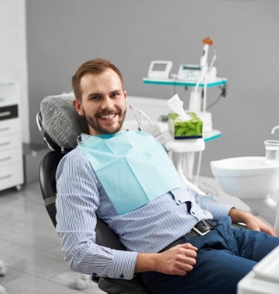 Smiling man sitting in dental chair