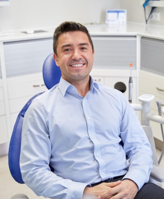 Smiling man sitting in dental chair