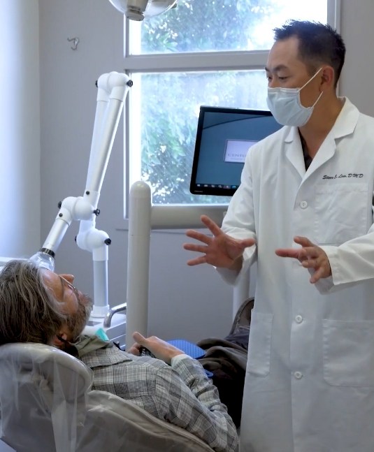 Doctor Lim talking to a patient during a preventive dentistry checkup in San Jose