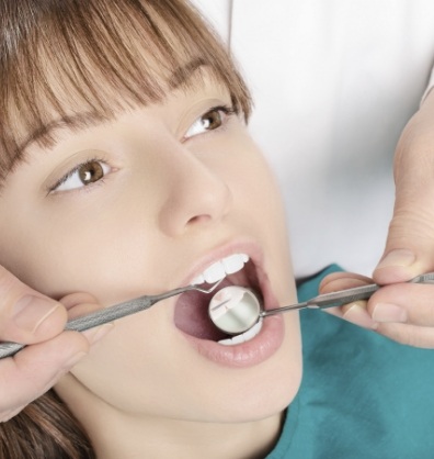 Woman in dental chair receiving a dental exam