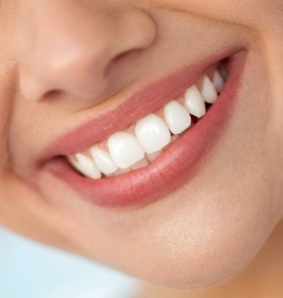 Close up of person smiling with flawless white teeth